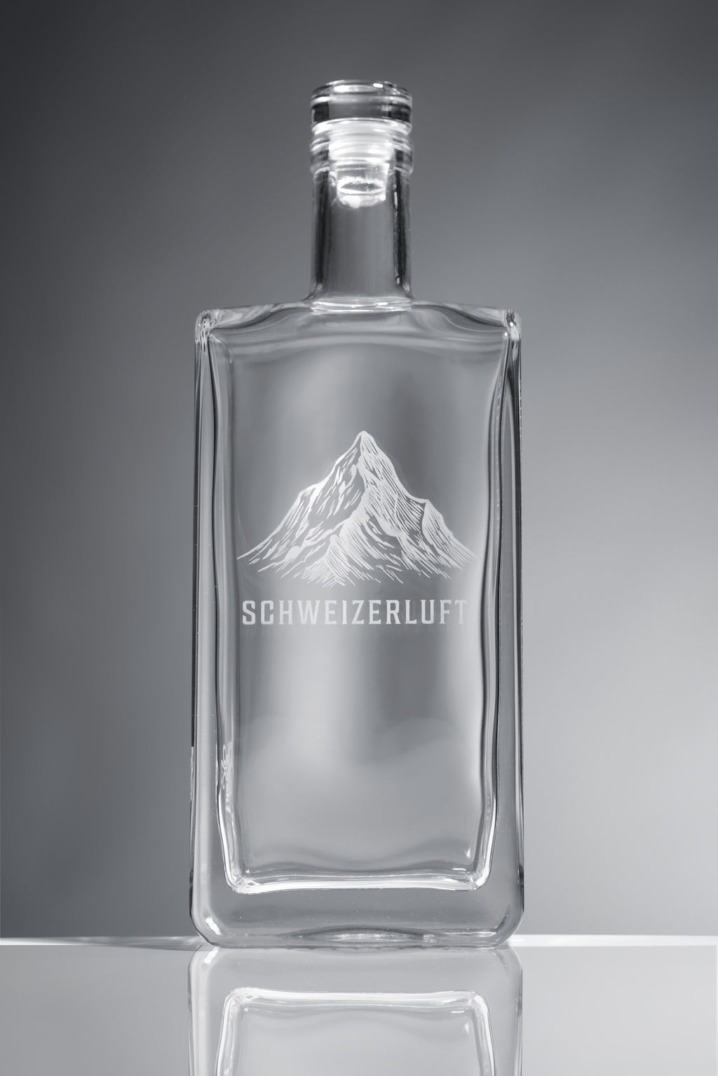 Detail view of clear, food-safe glass bottle showing thickness, edges, and craftsmanship.